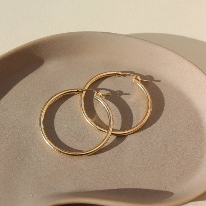 large gold hoop earrings on dish