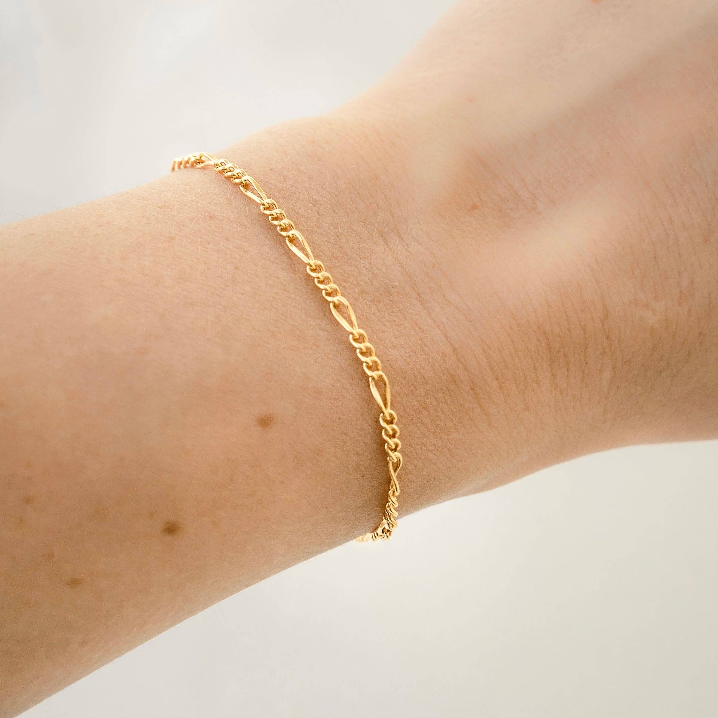 Delicate gold chain bracelet worn on a wrist, showcasing its elegant design